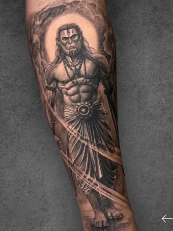 Witness the strength and divine aura of this Lord Parshuram tattoo, designed in hyper-realistic black & grey style. Every detail from the fierce expression to the sacred ornaments brings out his warrior spirit. Created at F19 Tattoo Studio, Pune – your destination for bold spiritual tattoos and custom designs.
